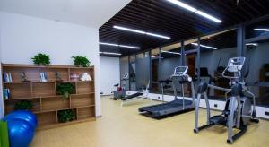 a gym with treadmills and ellipticals in a room at Atour Hotel Xiamen Jimei University in Xiamen