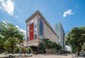 a building with a red sign on the side of it at Atour Hotel Shenzhen Luohu Vientiane City in Shenzhen