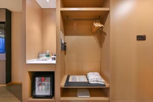 a bathroom with a sink and a toilet in a room at Atour Hotel Shenyang Nanta Wenhua Road in Shenyang