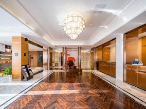 an office lobby with a large chandelier at Atour Hotel Shanghai Pudong Jinqiao International Commercial Plaza in Shanghai