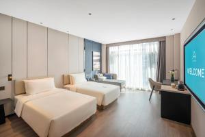 Ένα ή περισσότερα κρεβάτια σε δωμάτιο στο Atour Hotel Chengdu High Tech West District Government Affairs Center +16 φωτογραφίες
