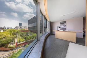 an office with a large window overlooking a city at Atour Hotel Shanghai Xinzhuang CBD in Shanghai