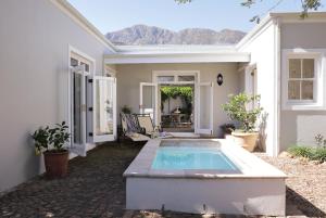 a house with a swimming pool in the yard at La Belle Vie in Franschhoek