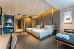 Ένα ή περισσότερα κρεβάτια σε δωμάτιο στο Atour Hotel Changzhou Wujin Science and Education City +17 φωτογραφίες