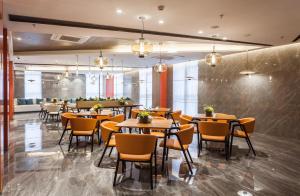 a restaurant with tables and chairs in a room at Atour Hotel Shenyang South Station Quanyun Road in Shenyang