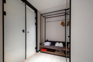 a dressing room with glass doors and a bench at Atour X Hotel Xiamen SM Plaza District Government in Xiamen