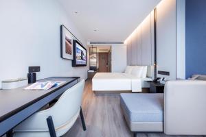 a hotel room with a bed and a desk at Atour Hotel Beijing South Xizhan Road in Beijing