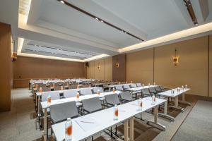 a large room with rows of tables and chairs at Atour Hotel Qingdao Tangdao Bay Jinggangshan Station in Huangdao