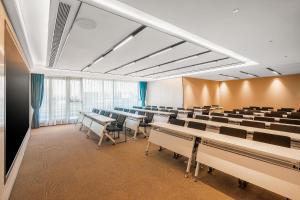 a lecture room with rows of tables and chairs at Atour Hotel Chengdu High Tech West District Government Affairs Center in Chengdu