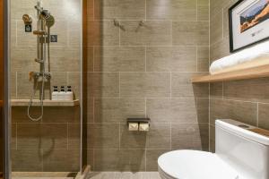 a bathroom with a shower and a toilet at Atour Hotel Beijing Wangjing Science and Technology Park in Beijing