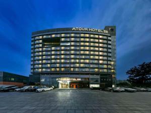 a building with a sign on top of it at Atour Hotel Beijing Yizhuang New Town Majuqiao in Daxing