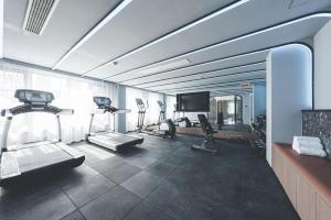 a gym with several exercise bikes and a television at Atour Light Hotel Hangzhou Xiasha in Hangzhou