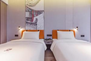 Ένα ή περισσότερα κρεβάτια σε δωμάτιο στο Atour Light Hotel Guiyang Fountain +18 φωτογραφίες