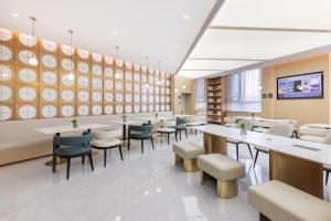 a restaurant with tables and chairs in a room at Atour Hotel Beijing South Xizhan Road in Beijing