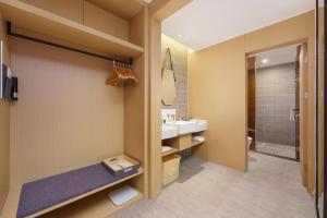 a bathroom with a sink and a shower at Atour S Hotel Xinghai Square in Dalian