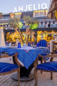 a blue table with chairs in front of a building at Anjeliq House Boutique Hotel in Alanya
