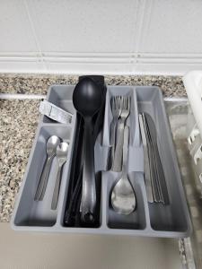 a tray with silver utensils on a counter at Oasis Hostel in Abu Dhabi