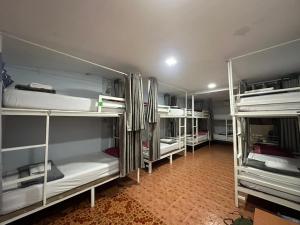 a room with white bunk beds in a room at Hangover Hostel in Phi Phi Islands