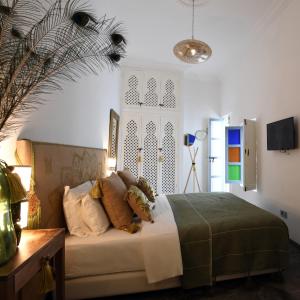 a bedroom with a bed in a room with a window at Riad CK Medina in Marrakech