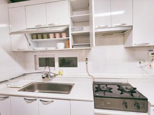 a kitchen with a stove and a sink at Raum in Seoul