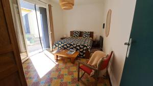 um quarto com uma cama, uma mesa e uma cadeira em chambre d'hôte chez l'habitant em Sète