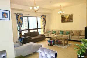 a living room with couches and a table at Marina Homes in Dubai