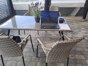 a laptop computer sitting on a table with two chairs at Nevada in Gdynia