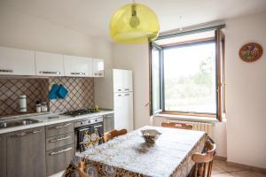 a kitchen with a table with a table cloth on it at #914 Home - Irpinia in Nusco
