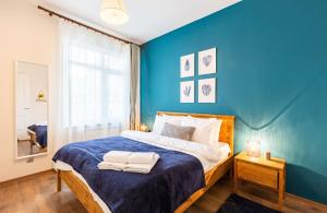 a blue bedroom with a bed with towels on it at Sleek in Istanbul