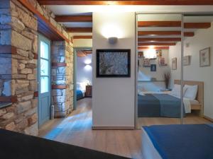 a bedroom with a bed in a room with a stone wall at Live at the Acropolis shadow - under super scenic Anafiotika in Athens