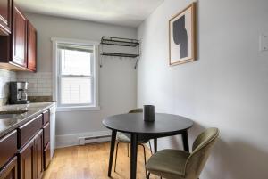 a kitchen with a table and two chairs and a window at South Boston 2br w building wd nr seaport BOS-915 in Boston