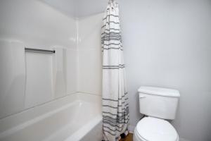 a bathroom with a toilet and a shower curtain at South Boston 2br w building wd nr seaport BOS-915 in Boston