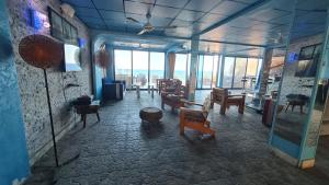 a room with chairs and tables in a room with windows at villa haroun in Dahab