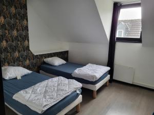 En eller flere senge i et værelse på APPARTEMENT DE GUISE 10