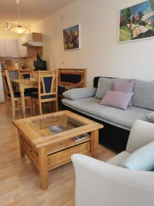 a living room with a couch and a coffee table at Wohnung Schluchseeglück mit Pool in Schluchsee