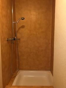a shower in a bathroom with a bath tub at Simple Appartment in the Center of Burgdorf 64 m2 with private Parking - SMALL BATHROOM in Burgdorf