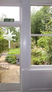 a door with a window with a view of a yard at Whitchester Christian Centre in Hawick