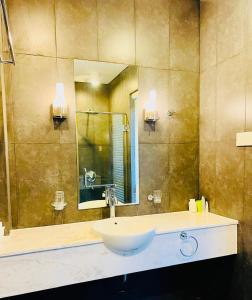 a bathroom with a sink and a mirror at D6 Aria Resort in Vung Tau