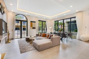 a living room with a couch and a table at Villa Wonderland Hồ Tràm LUXURY in Ho Tram
