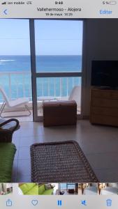 a living room with a view of the ocean at VV YELYMAR. PLAYA DE ALOJERA in Alojera