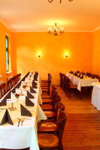 a row of tables and chairs in a restaurant at Landgasthof Rieben in Beelitz