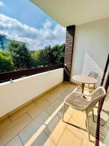 a balcony with a table and chairs on a balcony at Luxury Apartment Top Location RDS, Aviva 5 min walk in Dublin