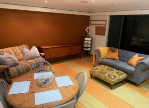 a living room with a table and a couch at Annie the Annex, A self contained home from home fully equipped space with street parking in Ilkeston