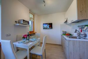 a small kitchen with a table and a sink at Studio La Borracina Mountain View - Happy Rentals in Sauze dʼOulx