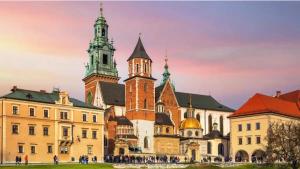 an old building with two towers in a city at 8 min to Castel & Main Square in Krakow