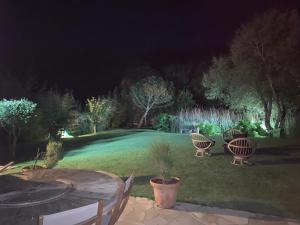 a backyard with a table and chairs at night at Villa Omaha in Saint-Laurent-sur-Mer