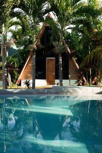 a house and a swimming pool in front of a house at Glamping Alona in Panglao