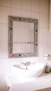 a bathroom with a sink and a mirror at Kilimanjaro Twin Rooms Queen Beds in Moshi