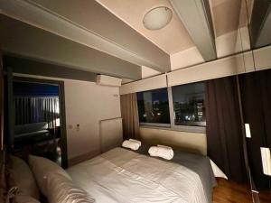 a bedroom with a bed with two towels on it at Penthouse W in Marousi Athens near Hospitals, by PromosHomes in Marousi