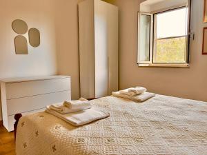 Postel nebo postele na pokoji v ubytování Carpine Agriturismo Bio in Maremma